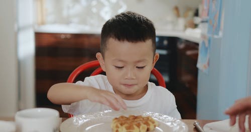 一个男孩吃华夫饼干吃早餐 · 免费素材视频