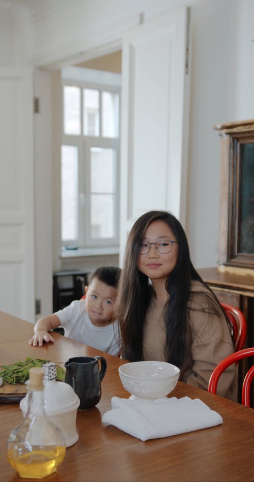 两个孩子在餐桌旁等待和坐 · 免费素材视频