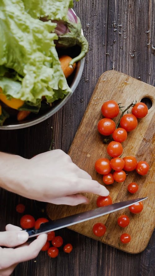 一个人用刀切西红柿的顶视图 · 免费素材视频
