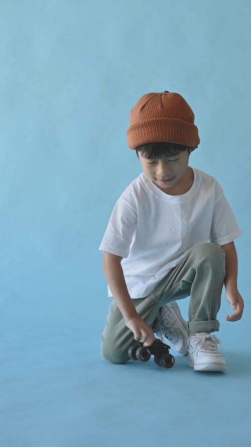 一个小男孩玩玩具车轮 · 免费素材视频